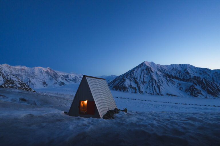a small house in a remote, snowy landscape